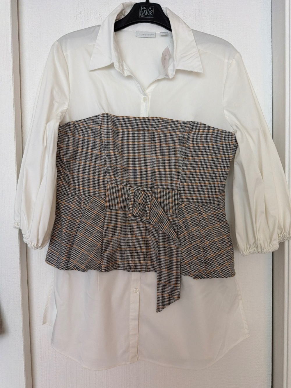 Stylish New York & Company top featuring a black and blush pink geometric print.